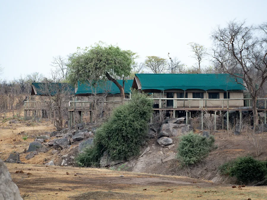 Safari camp buildings among trees in Hwange