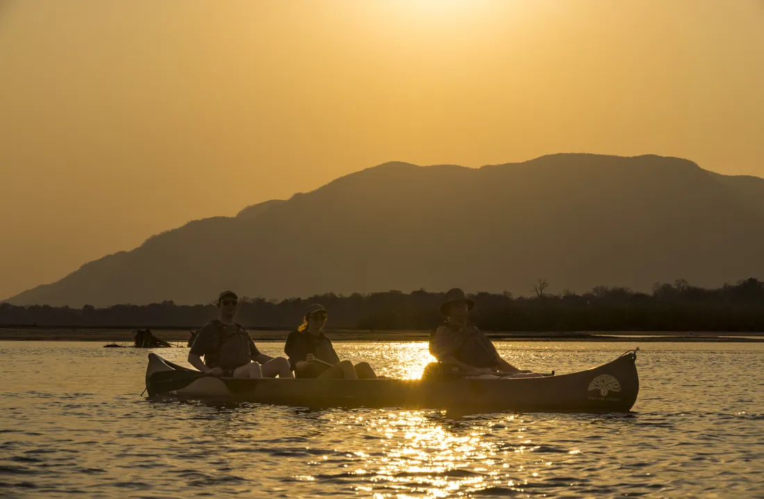 Canoes on a river at sunset